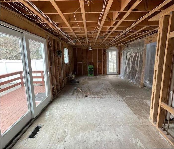 room stripped to framing and plywood flooring