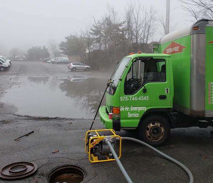 A flooded parking lot being pumped out by SERVPRO