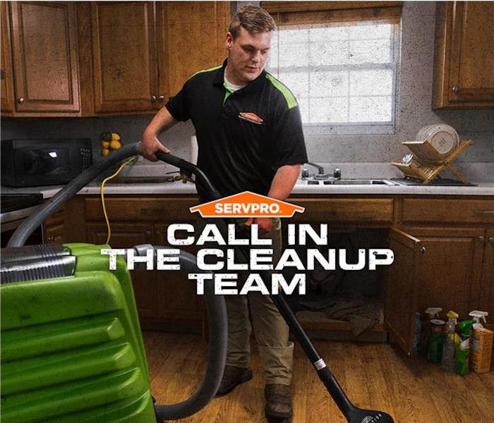 tech vacuuming water from kitchen floor