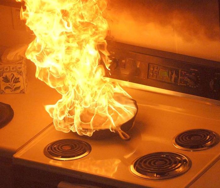 A pan fire on top of  a stove